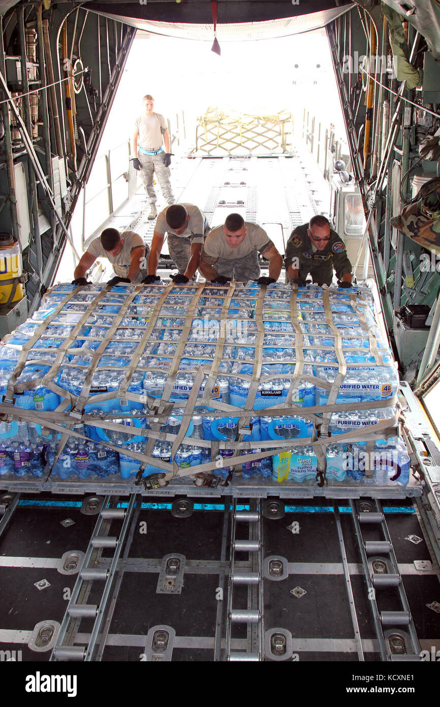 Airmen from several units assigned to Joint Base Andrews and from the Puerto Rico Air National Guard work to load donated humanitarian supplies on to a Puerto Rican C-130 Hercules for transport from Andrews to Puerto Rico, Oct. 5, 2017. The supplies came from several different groups around the Washington D.C. area that donated to the effort to support Puerto Rico in the aftermatht of Hurricane Maria, which hit the island on Sept. 20. (U.S. Air National Guard photo by Tech. Sgt. Dan Heaton) Stock Photo