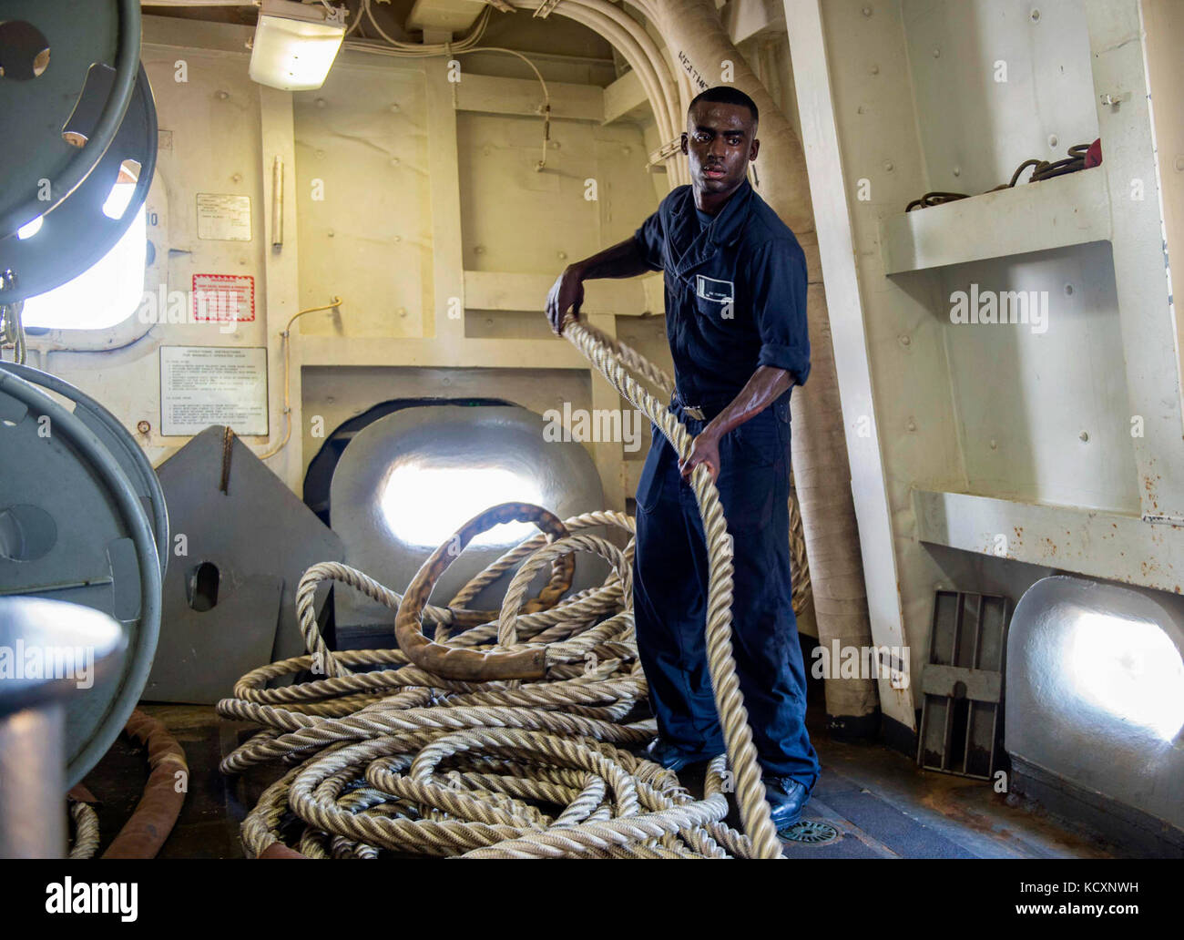 171007-N-YL073-0098   MAYPORT, Fla. (Oct. 7, 2017) Seaman Garry Tobias, a native of New Orleans, fakes a line during sea-and-anchor evolutions aboard the amphibious transport dock ship USS New York (LPD 21). New York departed Naval Station Mayport, Florida, to support the Gulf coast region in the event assistance is needed in the wake of Hurricane Nate. (U.S. Navy photo by Mass Communication Specialist 1st Class Shamira Purifoy/Released) Stock Photo