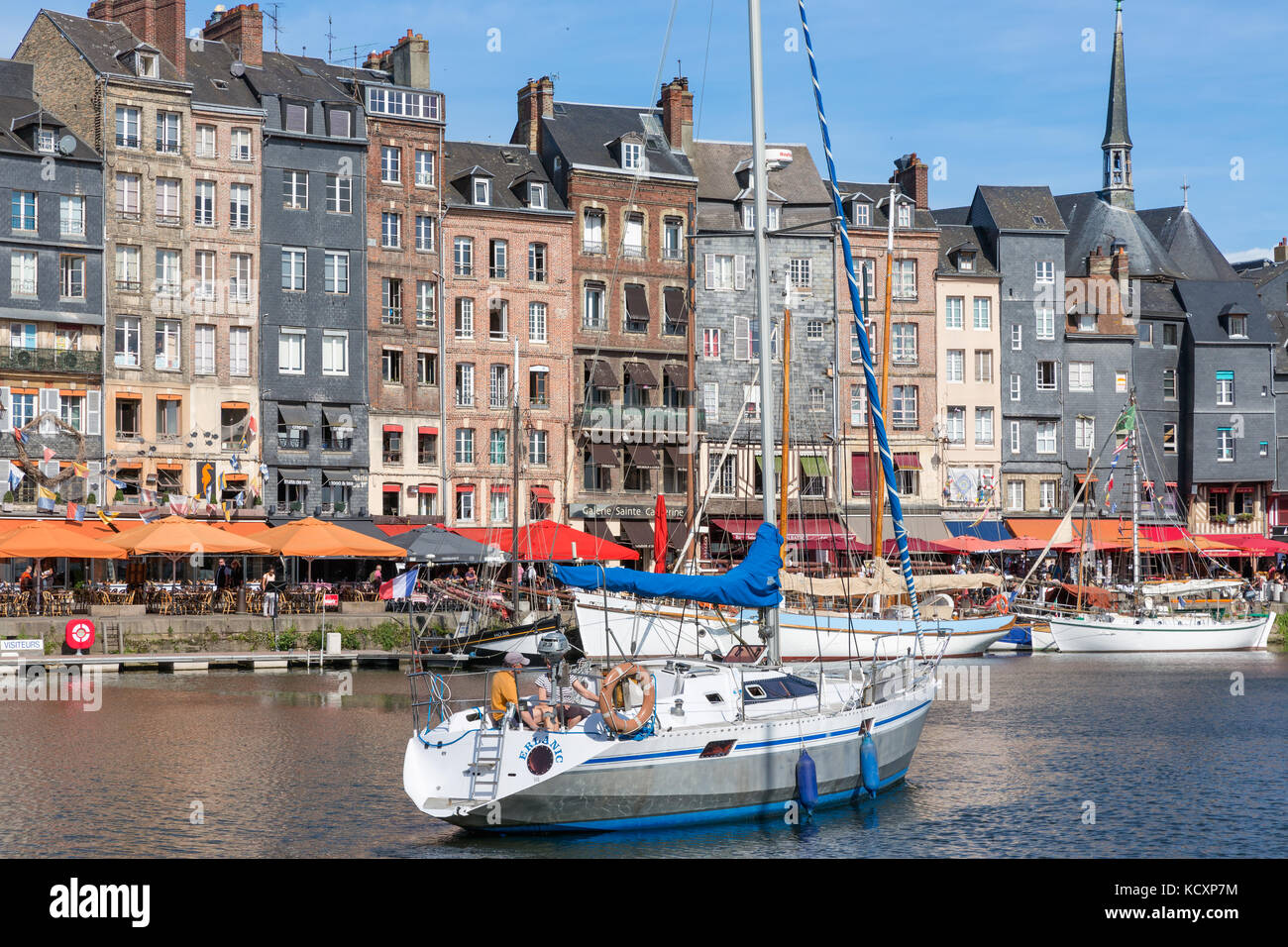 Harbor of historic city Honfleur with manoeuvring sailing ship Stock ...