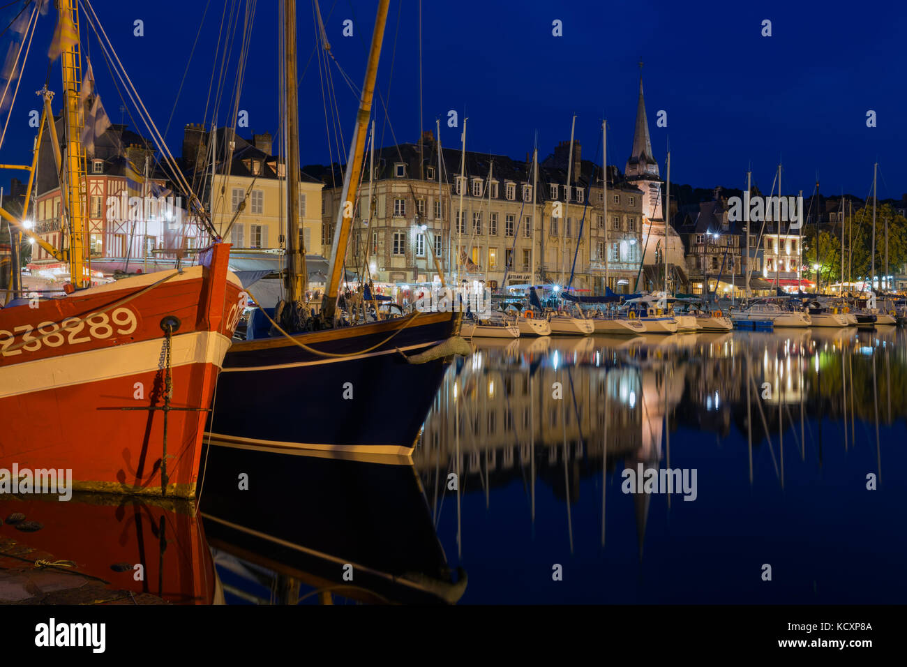 Historic harbor Honfleur with sailing ships in the evening, France ...