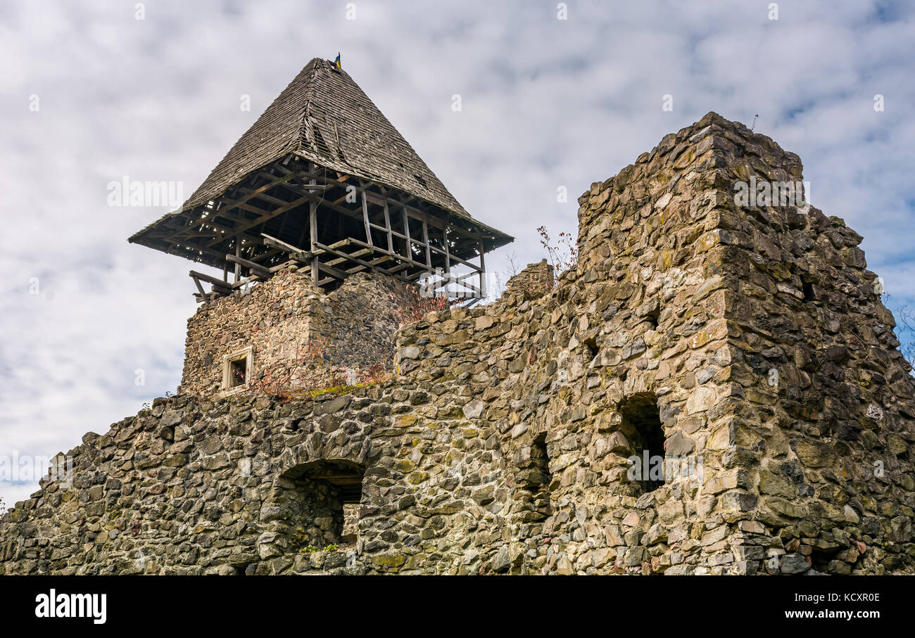 Nevytsky Castle, Ukraine - October 27, 2016: tower with wooden roof and stone wall of mighty Nevytsky Castle. popular travel destination of Transcarpa Stock Photo