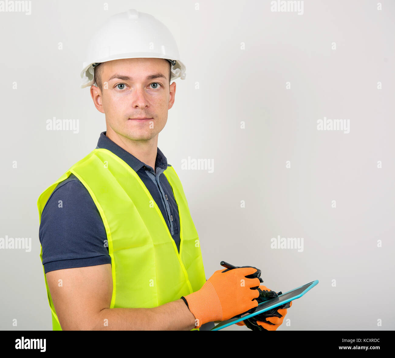 Builder in a helmet and vest Stock Photo Alamy