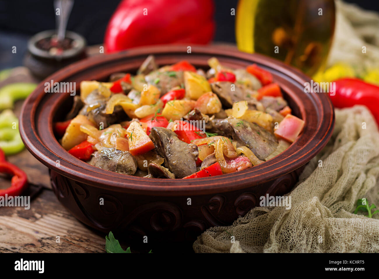 Roast chicken liver with vegetables on wooden background. Stock Photo
