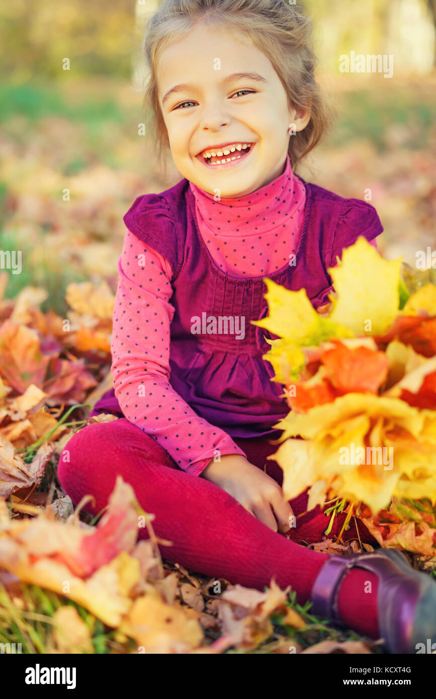 Happy little girl with autumn leaves Stock Photo - Alamy