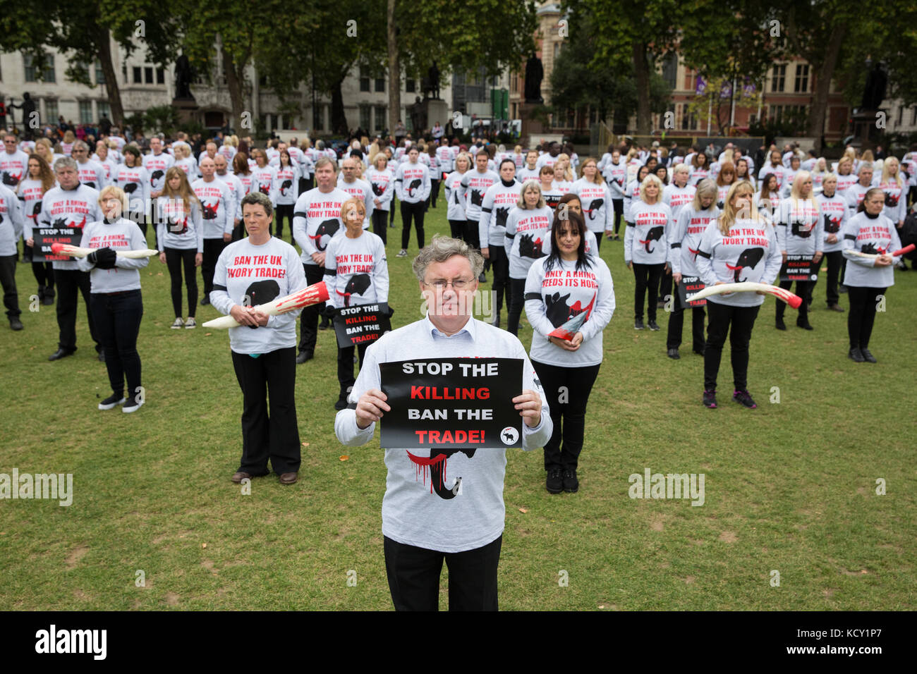 London, UK. 7th October, 2017. Duncan McNair, practising lawyer, author and founder and CEO of Save The Asian Elephants (STAE), stands at the front of a triangle of campaigners against the ivory trade taking part in a silent protest in Parliament Square to mark the fourth Global March for Elephants and Rhinos' March Against Extinction, intended not only to raise awareness of the plight of elephants and rhinos and the role of the antiques industry but also to apply pressure on the British Government to maintain a full ban on ivory. Credit: Mark Kerrison/Alamy Live News Stock Photo