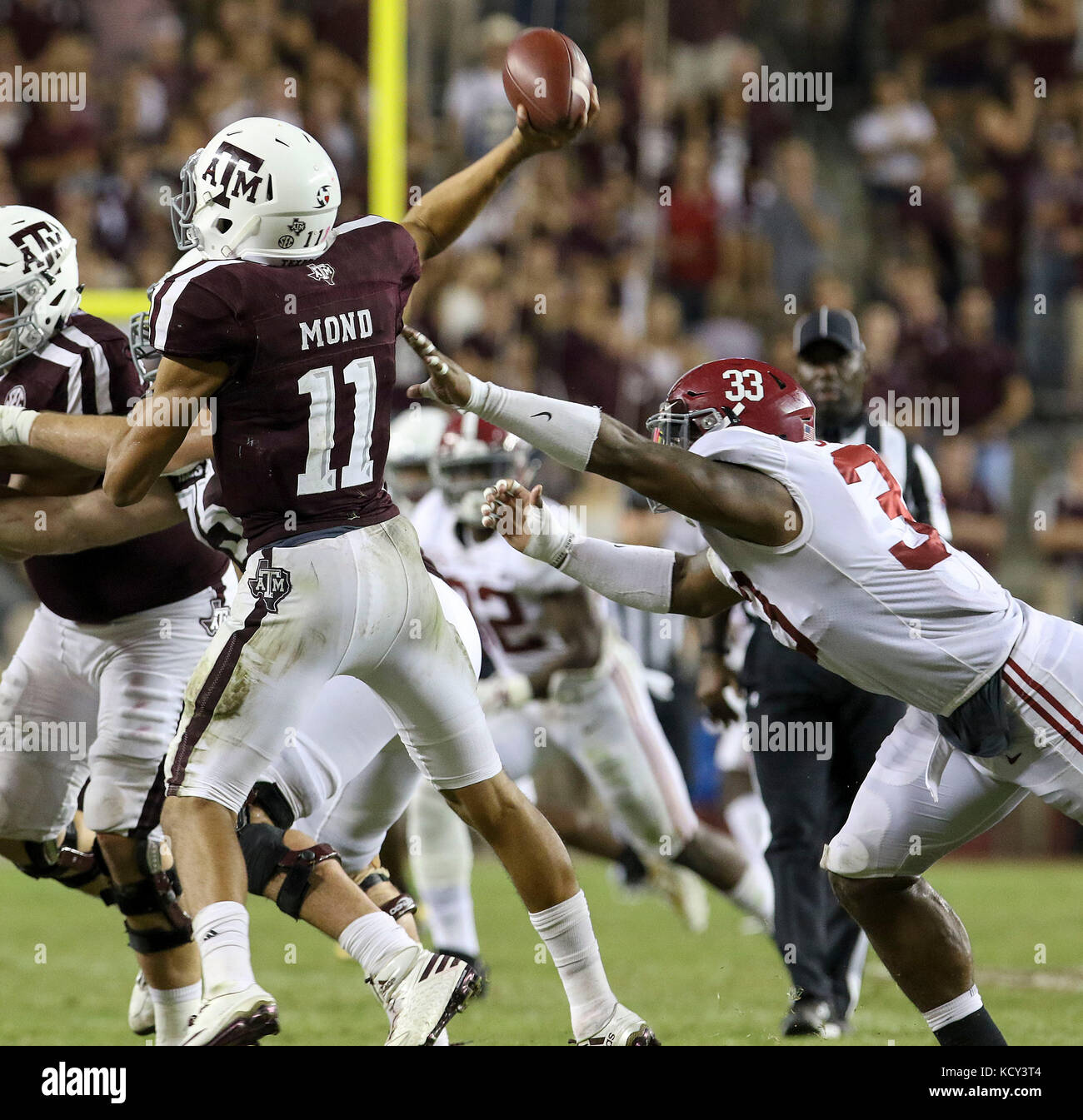 October 6, 2017: Texas A&M Aggies quarterback Kellen Mond (11) throws a pass while being pressured by Alabama Crimson Tide linebacker Anfernee Jennings (33) during the NCAA football game between the Alabama Crimson Tide and the Texas A&M Aggies at Kyle Field in College Station, TX; John Glaser/CSM. Stock Photo