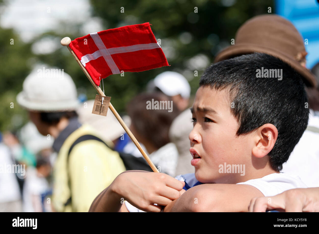 Tokyo, Japan. 8th October, 2017. A boy holding a Denmark flag waits to greet His Royal Highness the Crown Prince Frederik Andre Henrik Christian and Her Royal Highness the Crown Princess Mary Elizabeth Donaldson during the Danish Festival and Walkathon at Toyosu Park on October 8, 2017, Tokyo, Japan. The Danish Crown Prince Couple attended the festival which celebrating 150 years of Diplomatic relations between Japan and Denmark. Stock Photo