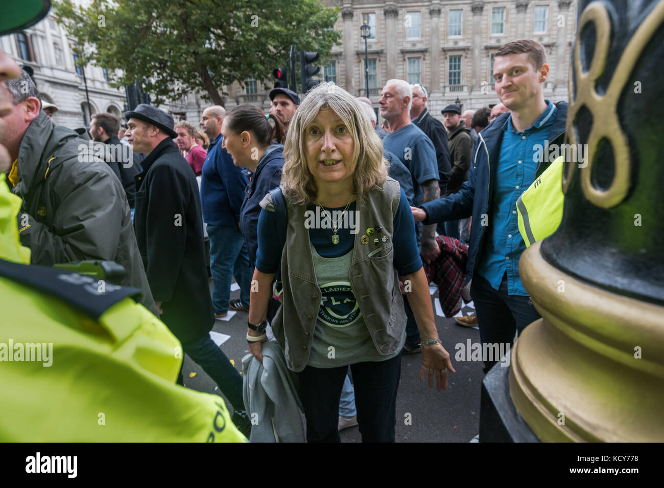 October 7, 2017 - London, UK. 7th October 2017. Police move in in large numbers to get marchers to move past Stand Up To Racism supporters handing out the flier 'Some questions for the leaders of the FLA' and continue their march . Although the FLA strongly denies accusations that they are racist and against Muslims in general, there were many former supporters of far-right groups such as the EDL among those marching. As the FLA marched past, a number of individuals came to shout abuse at those handing out the fliers, threatening them and photographers. One man pulled all of the fliers one p Stock Photo