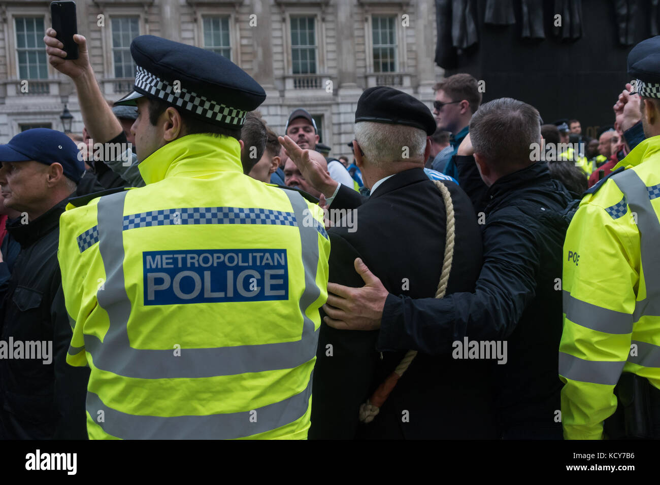 October 7, 2017 - London, UK. 7th October 2017. Police move in in large numbers to get marchers to move past Stand Up To Racism supporters handing out the flier 'Some questions for the leaders of the FLA' and continue their march . Although the FLA strongly denies accusations that they are racist and against Muslims in general, there were many former supporters of far-right groups such as the EDL among those marching. As the FLA marched past, a number of individuals came to shout abuse at those handing out the fliers, threatening them and photographers. One man pulled all of the fliers one p Stock Photo