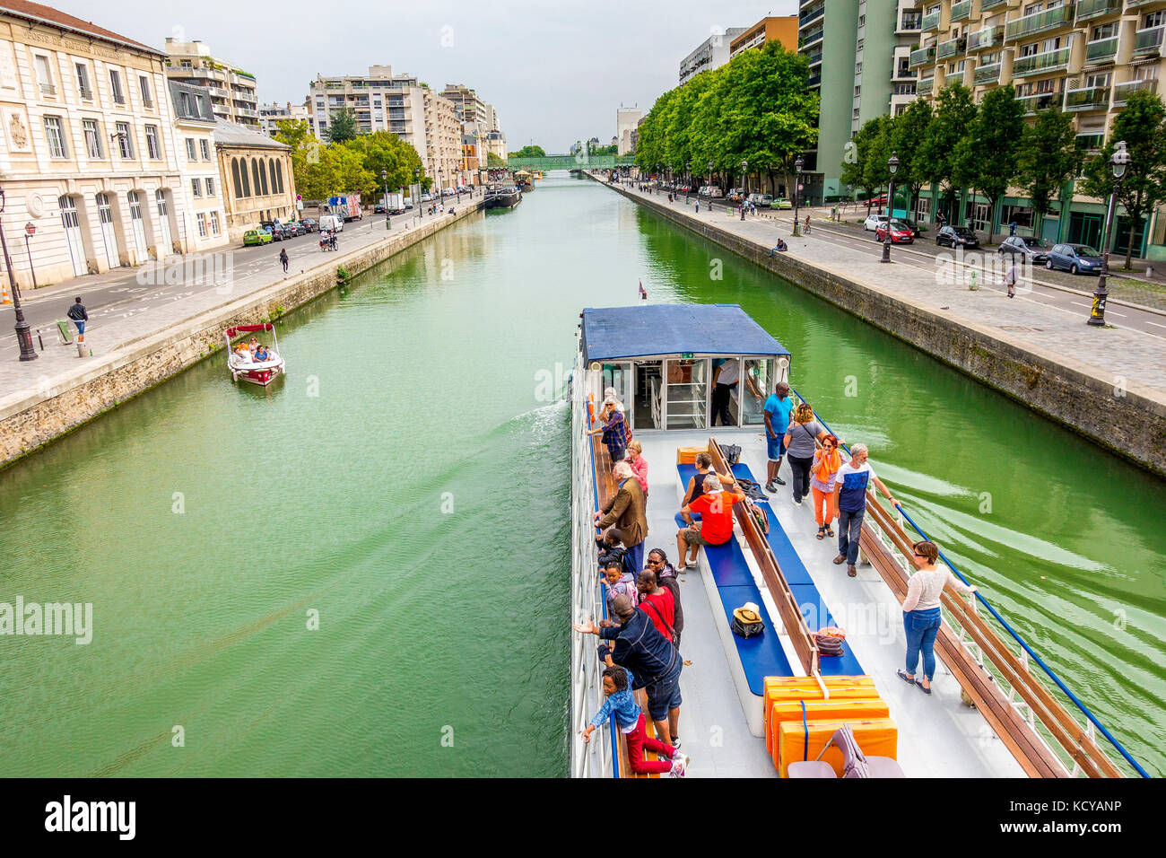 A River cruise boats leaving the Bassin de la Villette after going through the Rue de Crimée lifting bridge in Paris, France Stock Photo