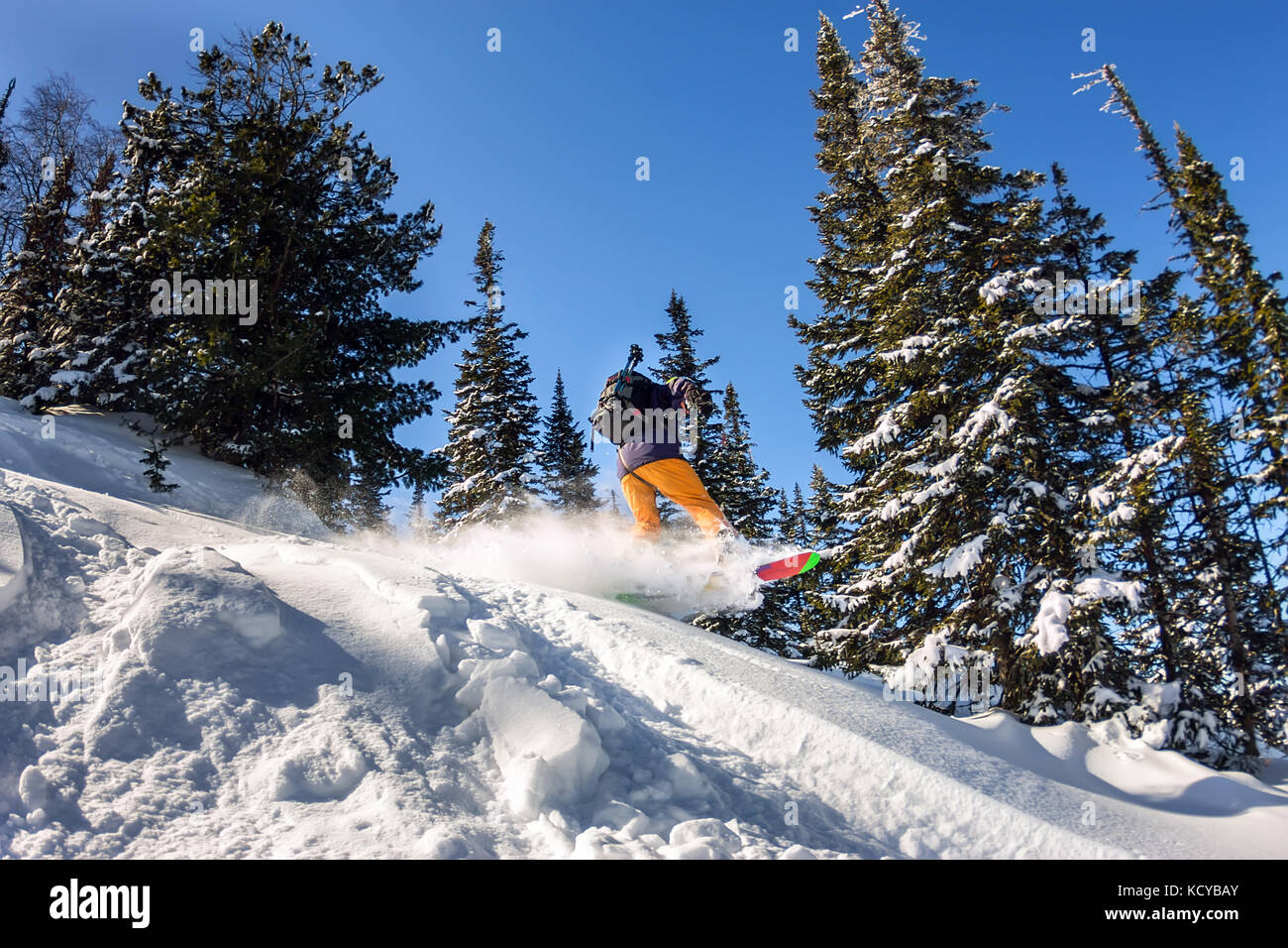 Snowboarder jump in snow powder backcountry freeride. Winter sports. Stock Photo