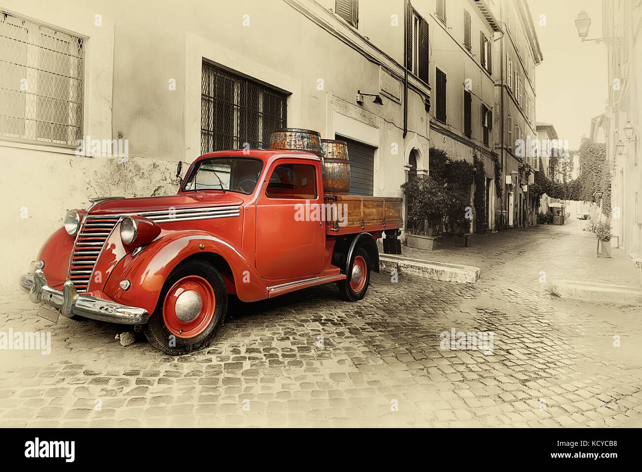 Red retro car on the street of Trastevere in Rome, Italy Stock Photo ...