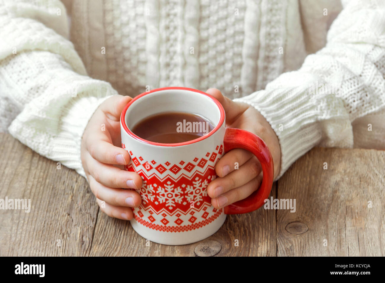https://c8.alamy.com/comp/KCYCJA/female-hands-holding-red-mug-of-hot-chocolate-coffee-on-rustic-wooden-KCYCJA.jpg