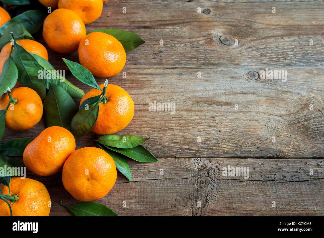 Tangerines (mandarins, clementines, citrus fruits) with leaves over