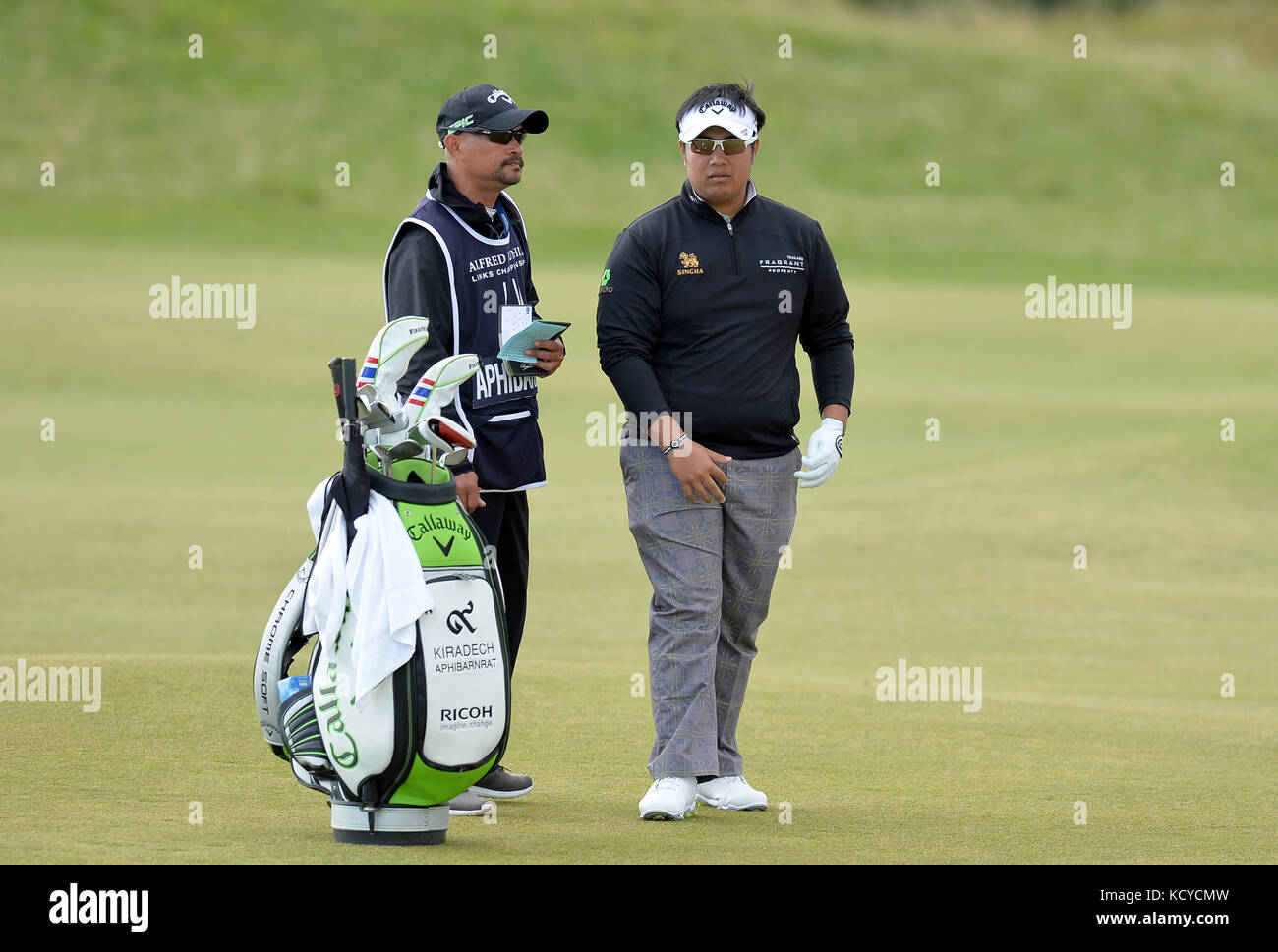 Thailand's Kiradech Aphibarnrat (right) waits to play his shot on the fourth fairway during day four of the Alfred Dunhill Links Championship atSt Andrews Old Course, Fife. Stock Photo