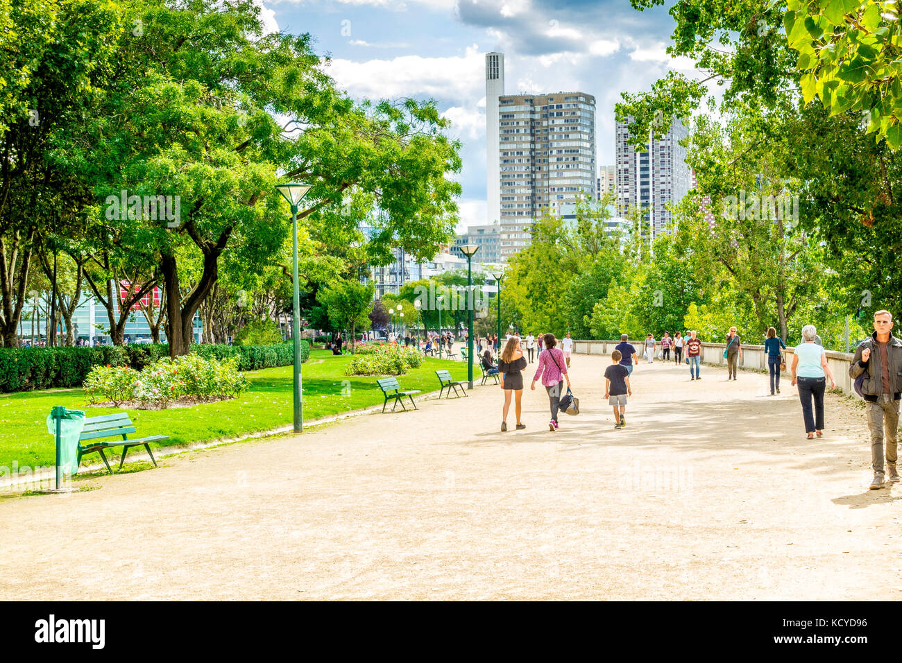 Tourists and locals stroll by the Seine River on a sunny day in Paris, France Stock Photo