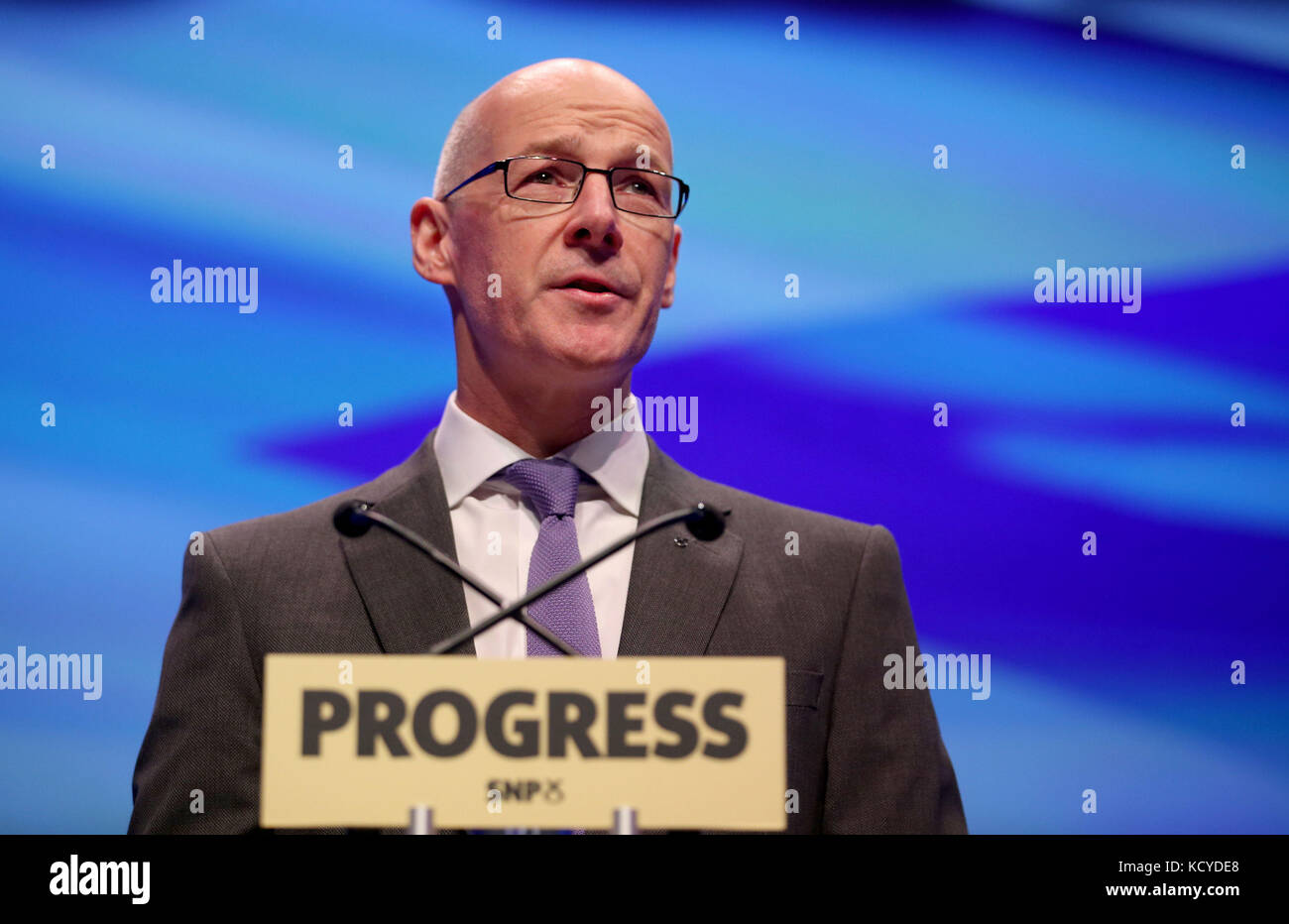 Deputy First Minister of Scotland John Swinney delivers the opening address to delegates at the Scottish National Party (SNP) conference at the SEC Centre in Glasgow. Stock Photo