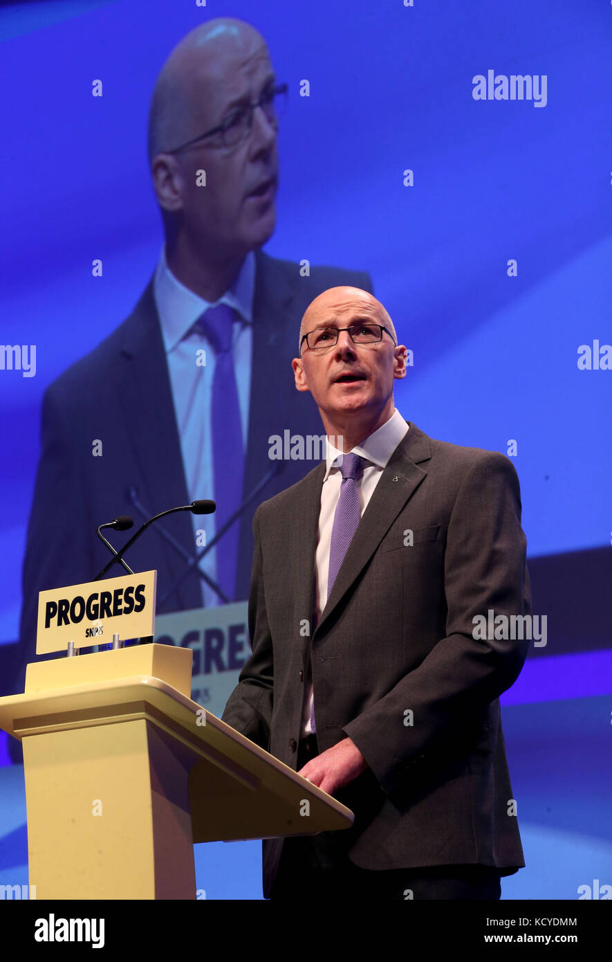 Deputy First Minister of Scotland John Swinney delivers the opening address to delegates at the Scottish National Party (SNP) conference at the SEC Centre in Glasgow. Stock Photo