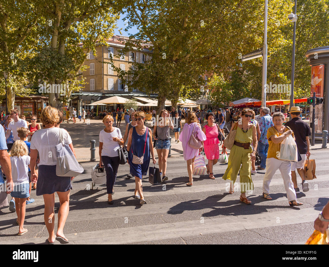 AIX-EN-PROVENCE, FRANCE - People crossing street at La Rotonde. Stock Photo