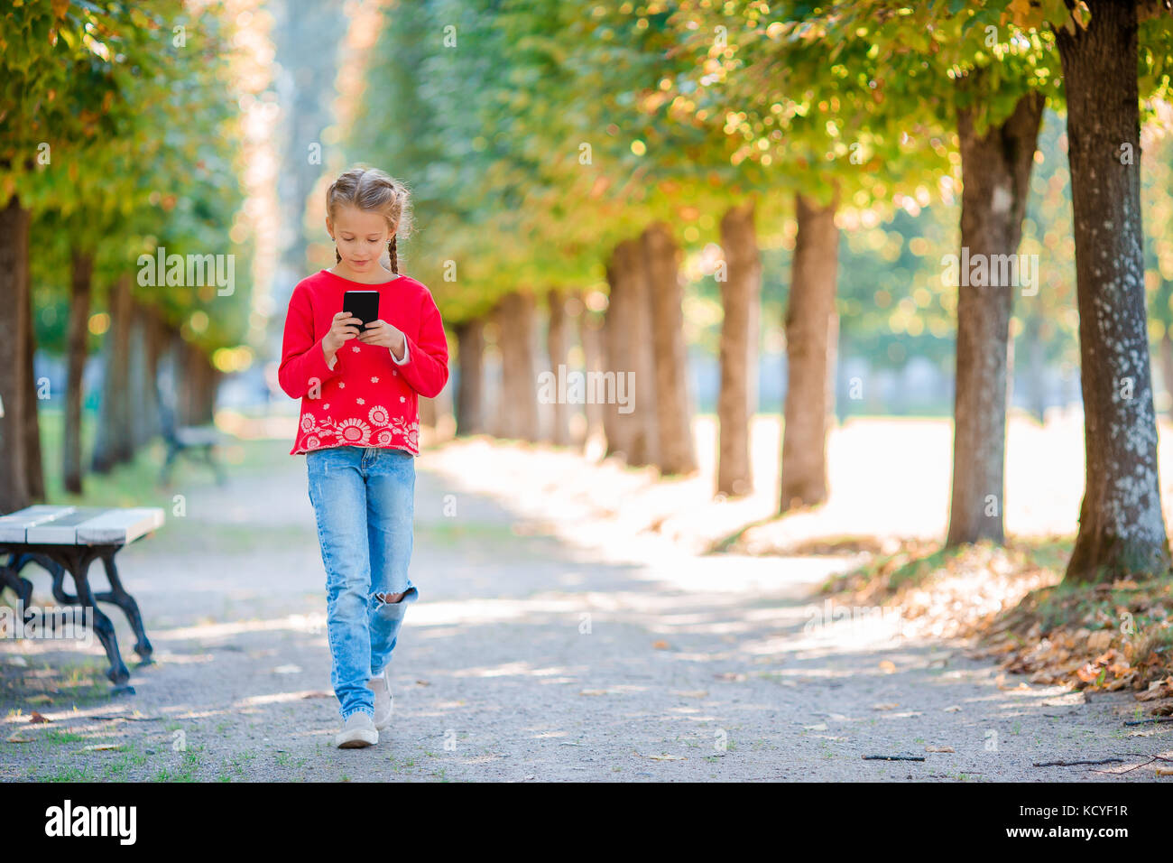 Little adorable girls at warm sunny autumn day outdoors Stock Photo - Alamy