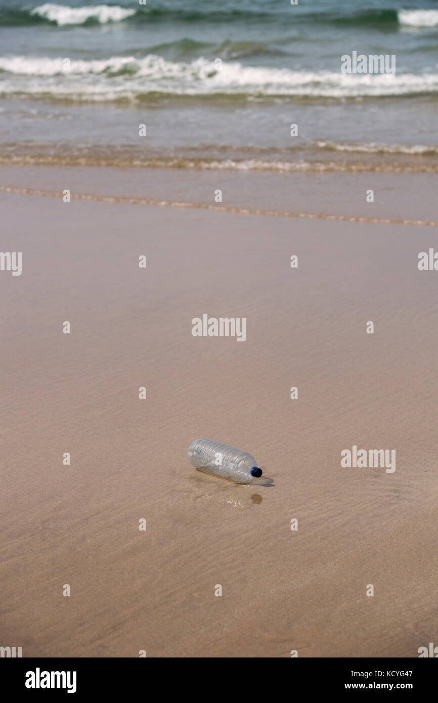 Plastic bottle polluting a sandy beach Stock Photo