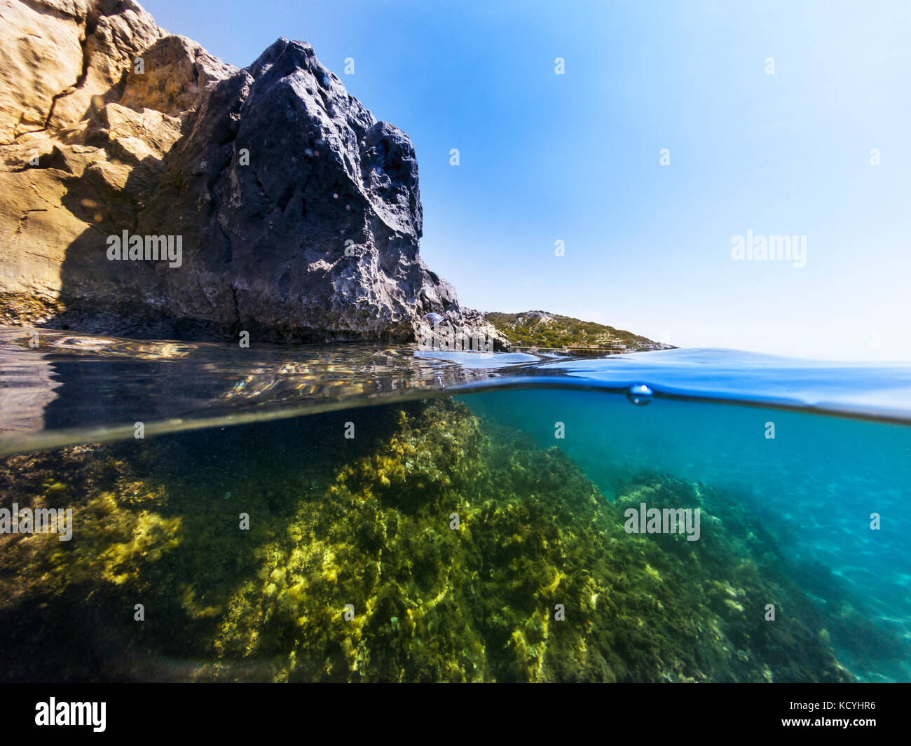 Half underwater in the sea with rocks and stones. Stock Photo