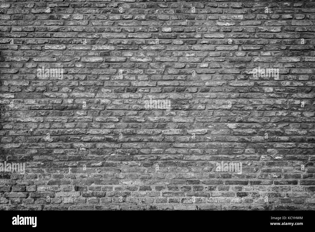 Old and aged brick wall texture background with vignette in black and ...