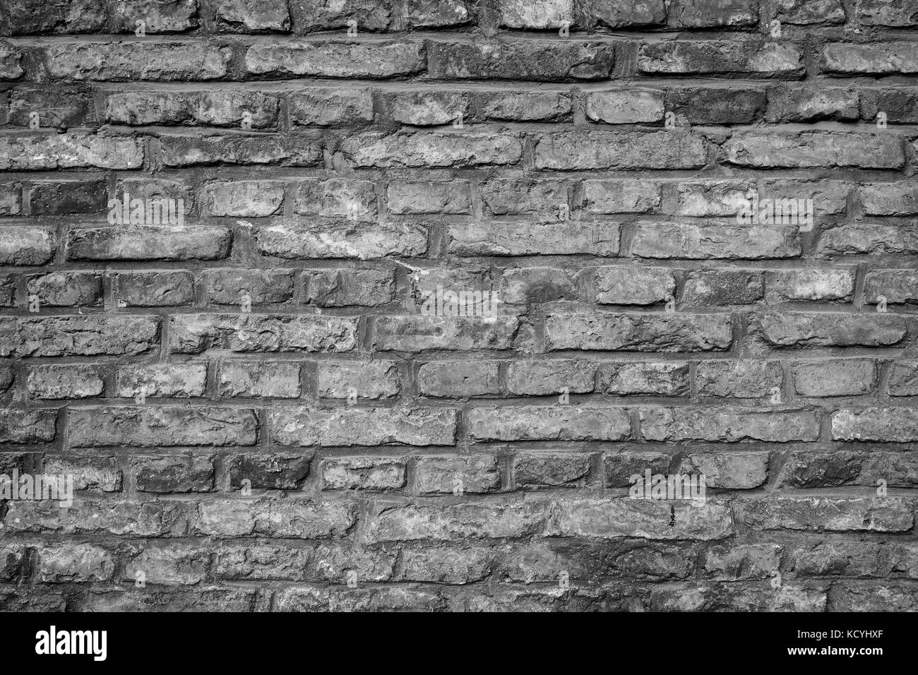 Close-up of an old and aged brick wall texture background with vignette ...