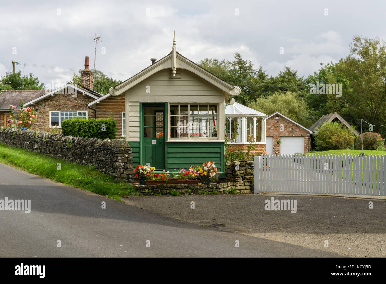 Old railway signal box in the North Yorkshire village of Coxwold; now part of an adjoining residential property. Stock Photo