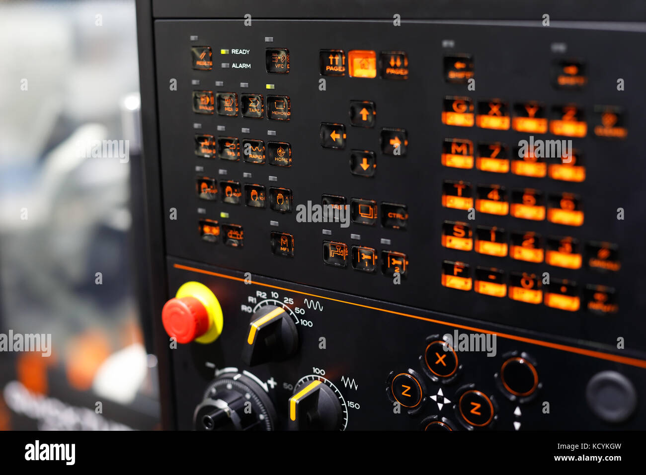 Switches and backlit buttons on the control panel of the CNC machining ...