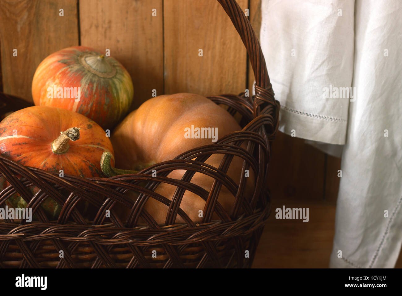 Ripe pumpkins on a wooden background and in a basket. Rustic style ...