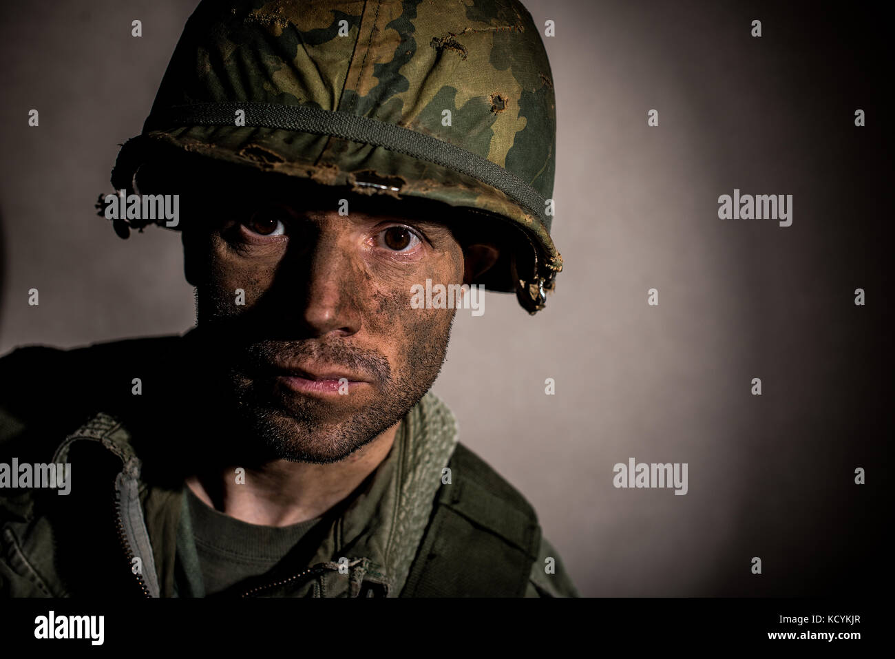 Shell shocked soldier (US Marine / Vietnam War) with face covered in dirt,  against a dark background Stock Photo - Alamy