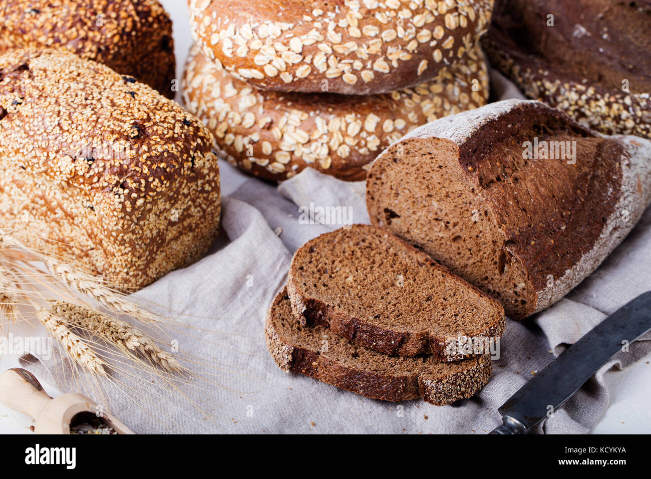 Fresh bread assortment on a textile background. Rustic background. Stock Photo