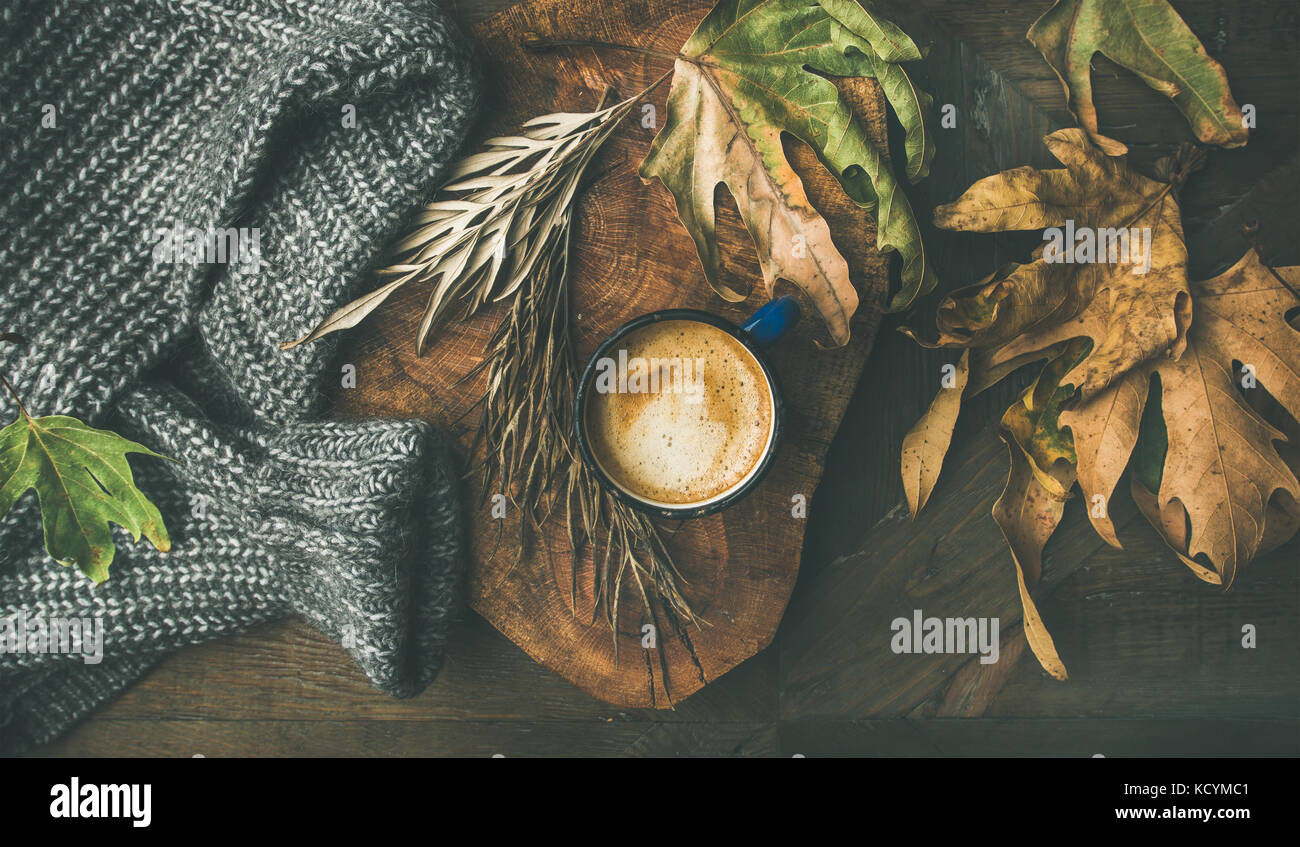 Autumn morning coffee concept with leaves and woolen sweater Stock Photo