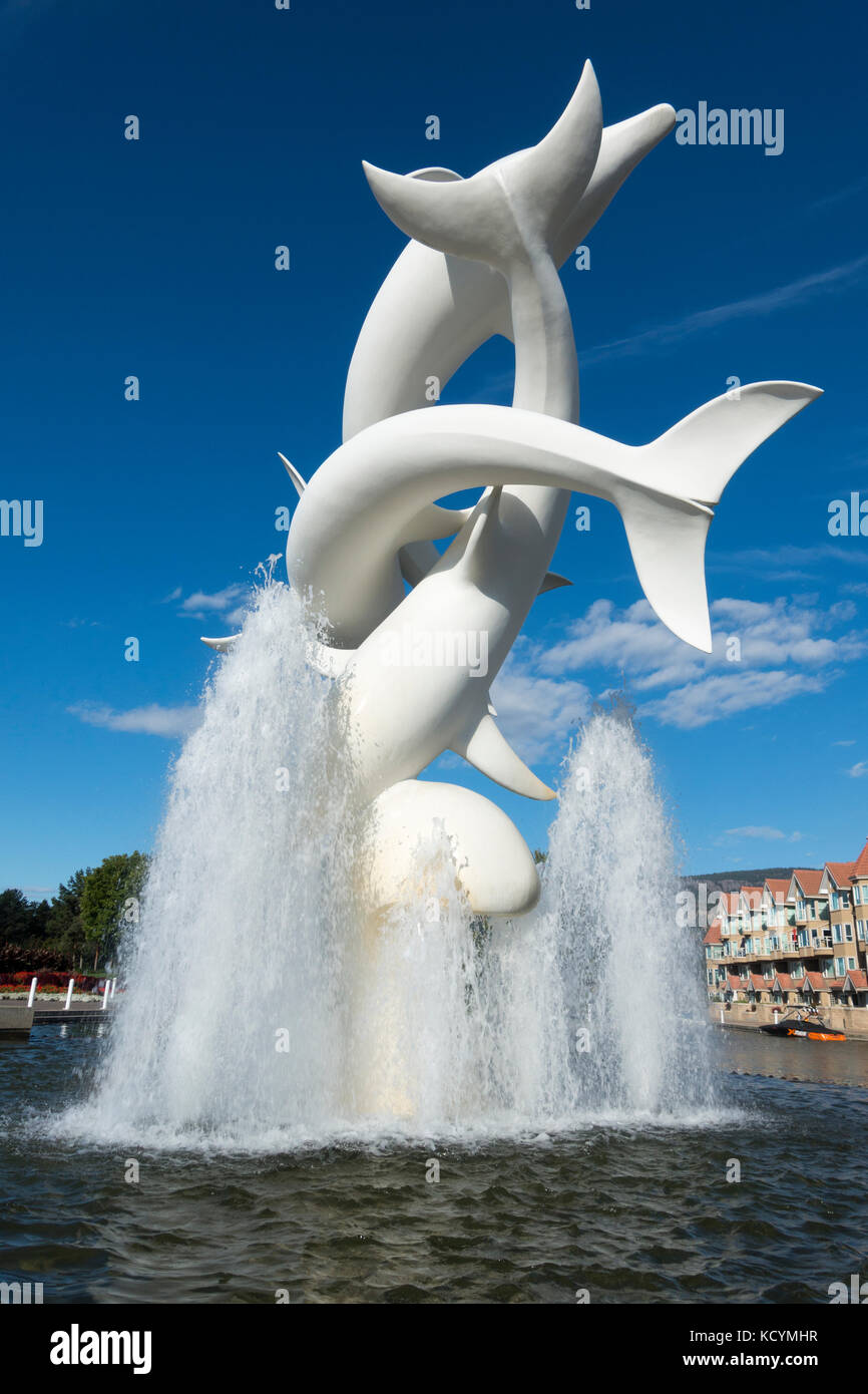 2017 Kelowna B.C - A well-known sculpture on the Lake Okanagan waterfront park entitled Rhapsody depicting a pod of dolphins playing in a fountain. Stock Photo