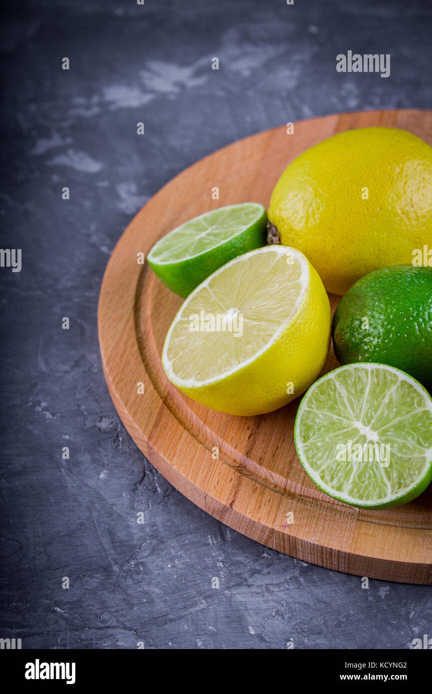 lemons and limes on a gray background Stock Photo Alamy