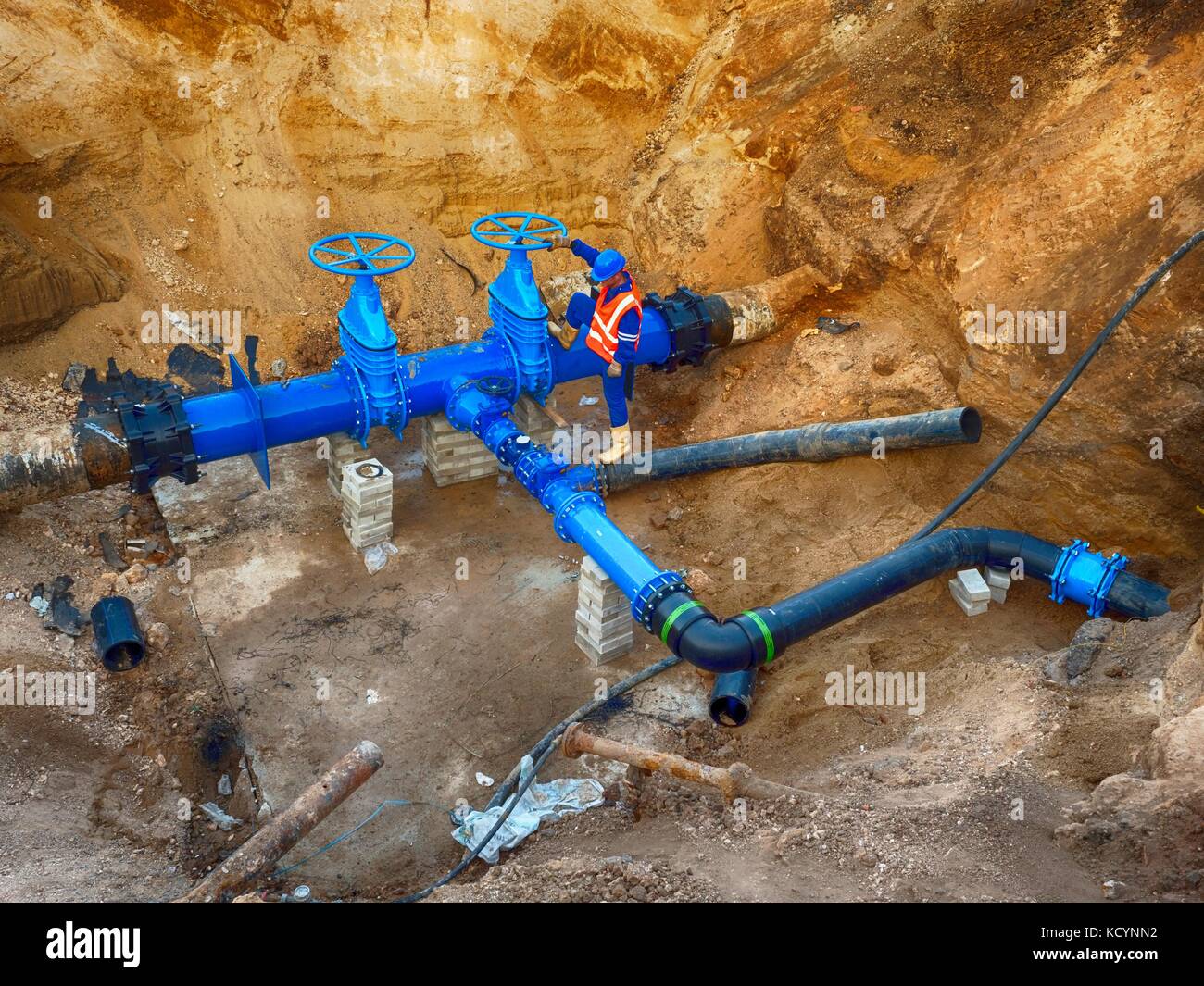 Technical expert underground at gate valve on 500mm drink water pipes joined with eccentric