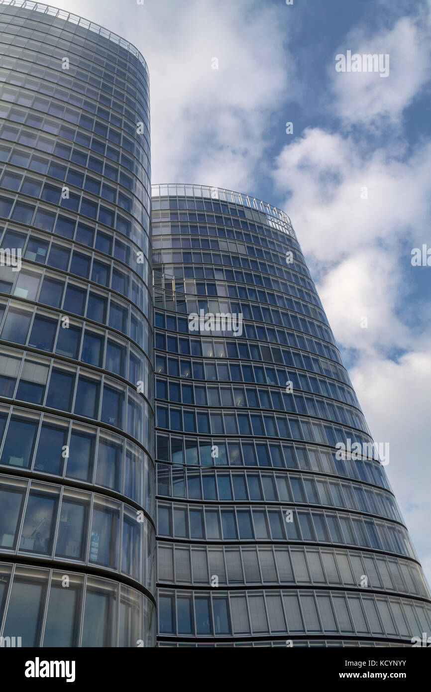 Glass modern building on a blue cloudy sky Stock Photo - Alamy