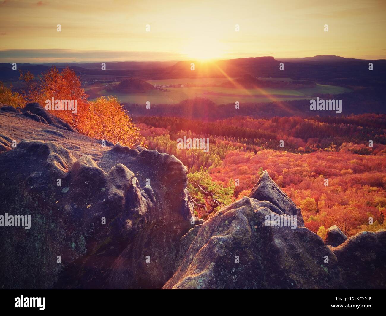 Fantastic dreamy sunset on top of rocky mountain with view into evening ...