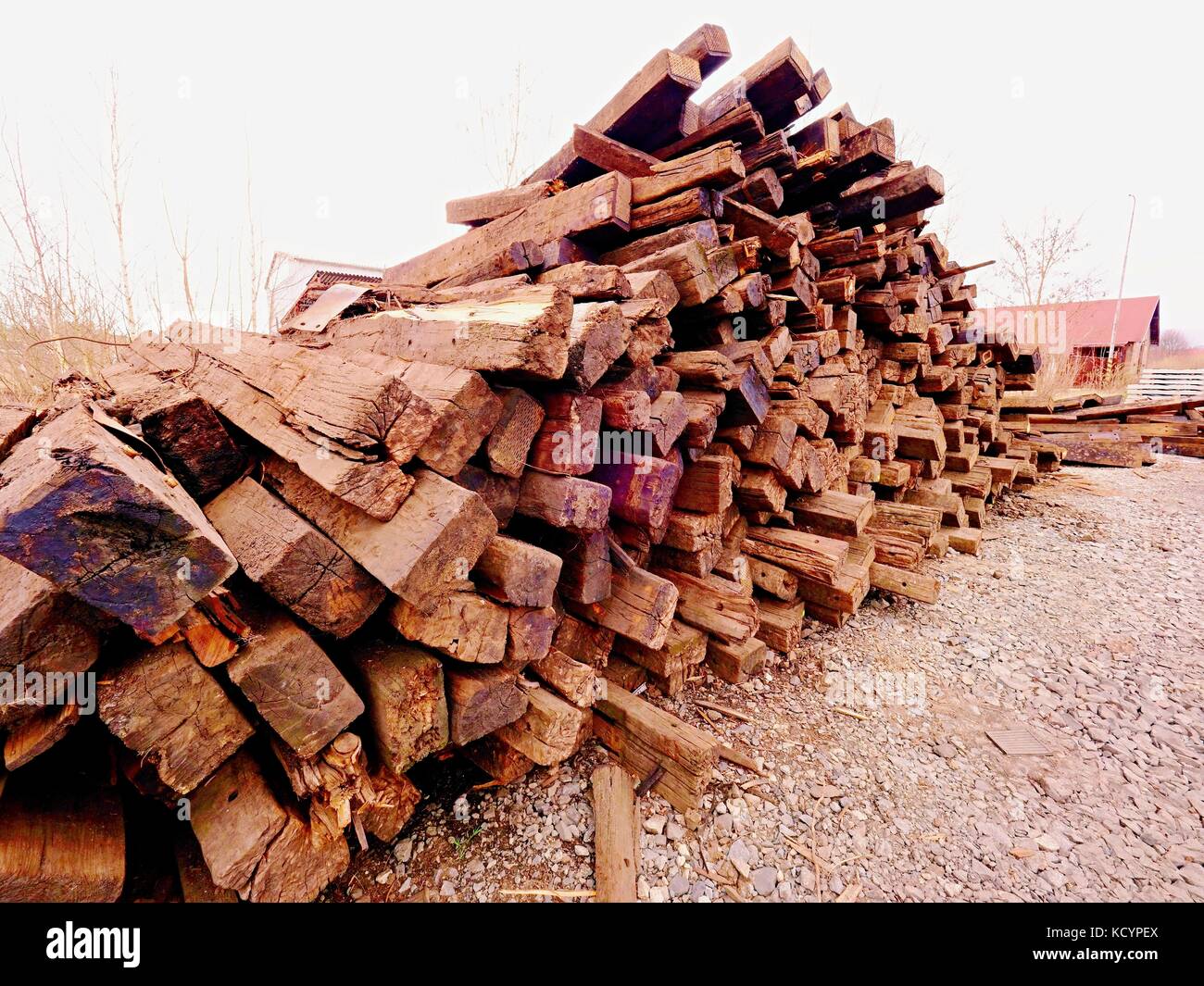 Terrible smell pile of extracted old wooden ties. Old oiled used oak