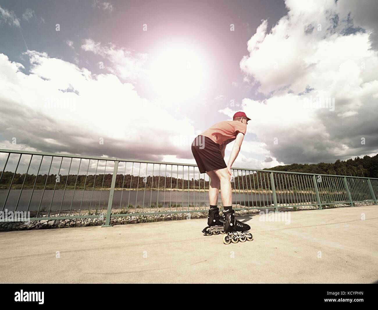 Roller skater in action. Man ride in inline skates ride along promenade