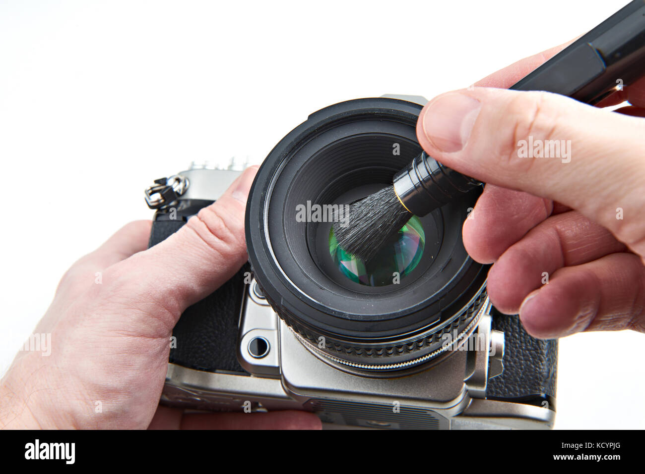 Cleaning the photographic lens from dust with a brush Stock Photo - Alamy