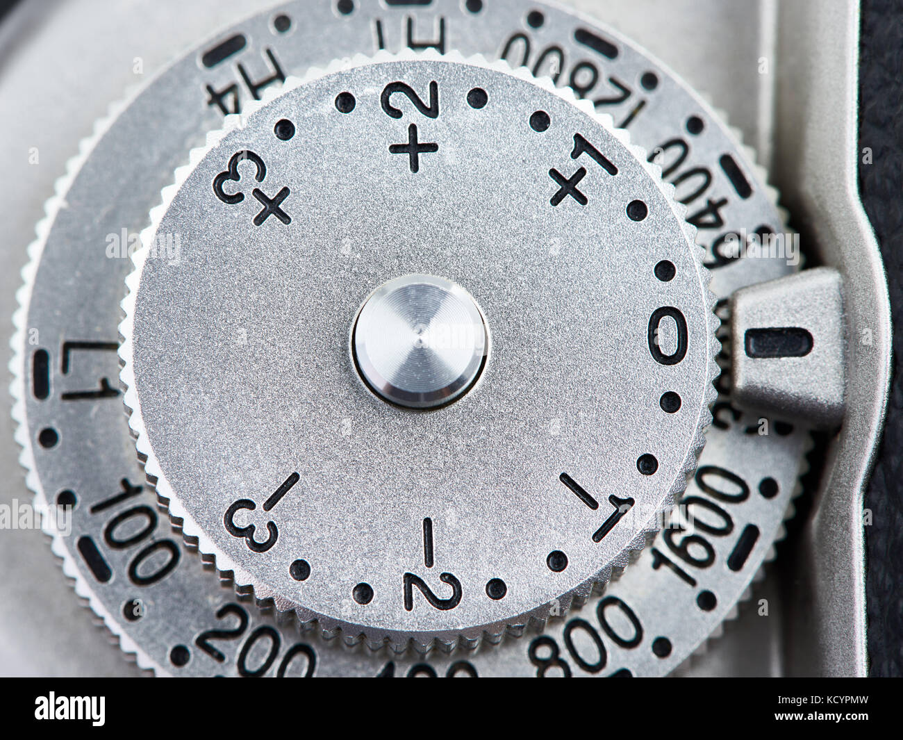 ISO and exposure compensation control dial on SLR camera closeup Stock
