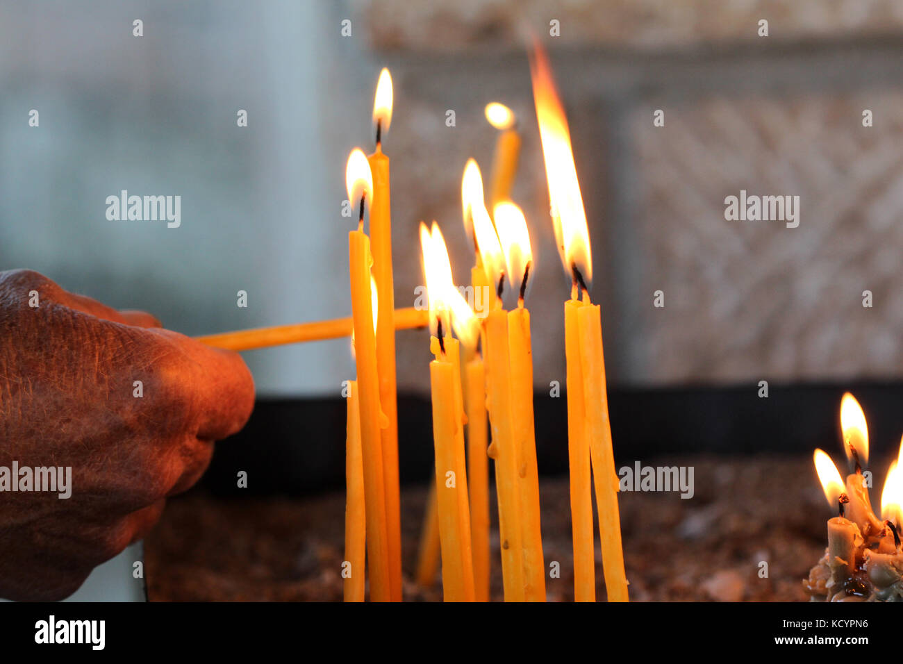 picture of a old man lights a candle Stock Photo - Alamy