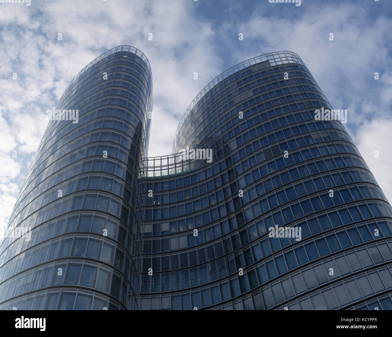 Glass modern building on a blue cloudy sky Stock Photo - Alamy