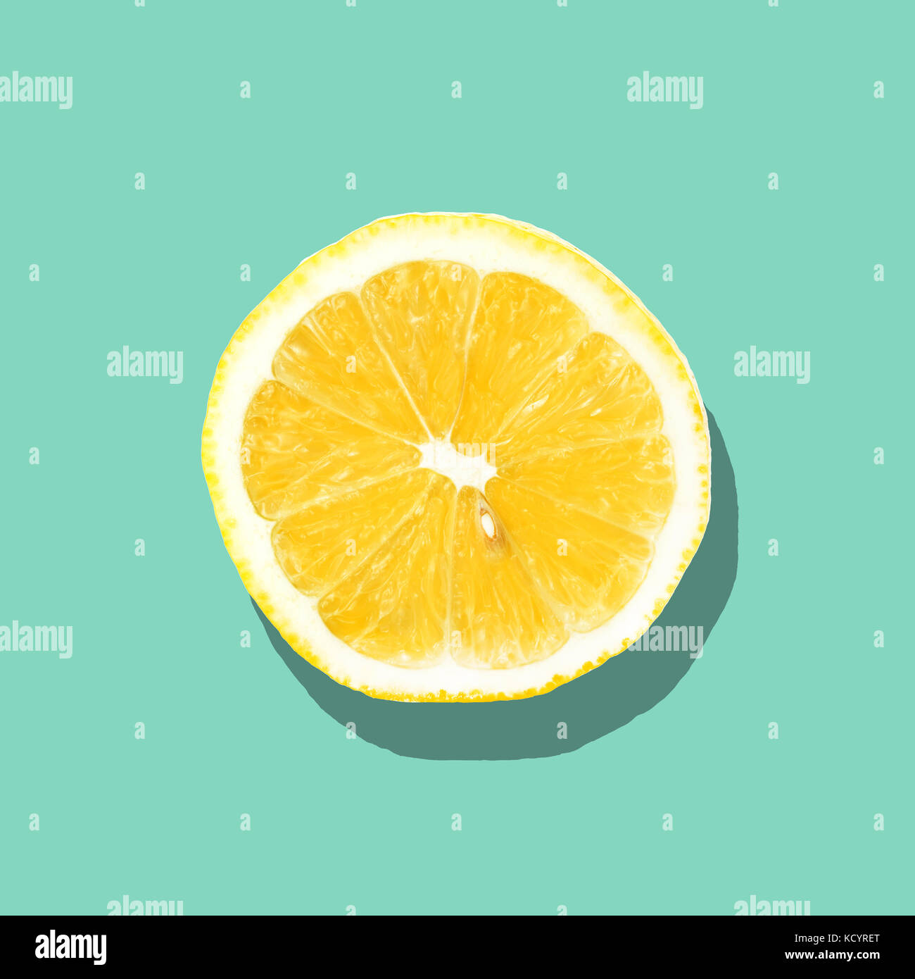 Fresh lemon slice close up on bright blue background. Flat lay. Summer concept. Stock Photo