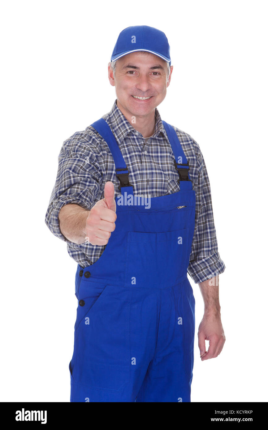 Mature Male Technician Making Thumbs Up Gesture Over White Background Stock Photo