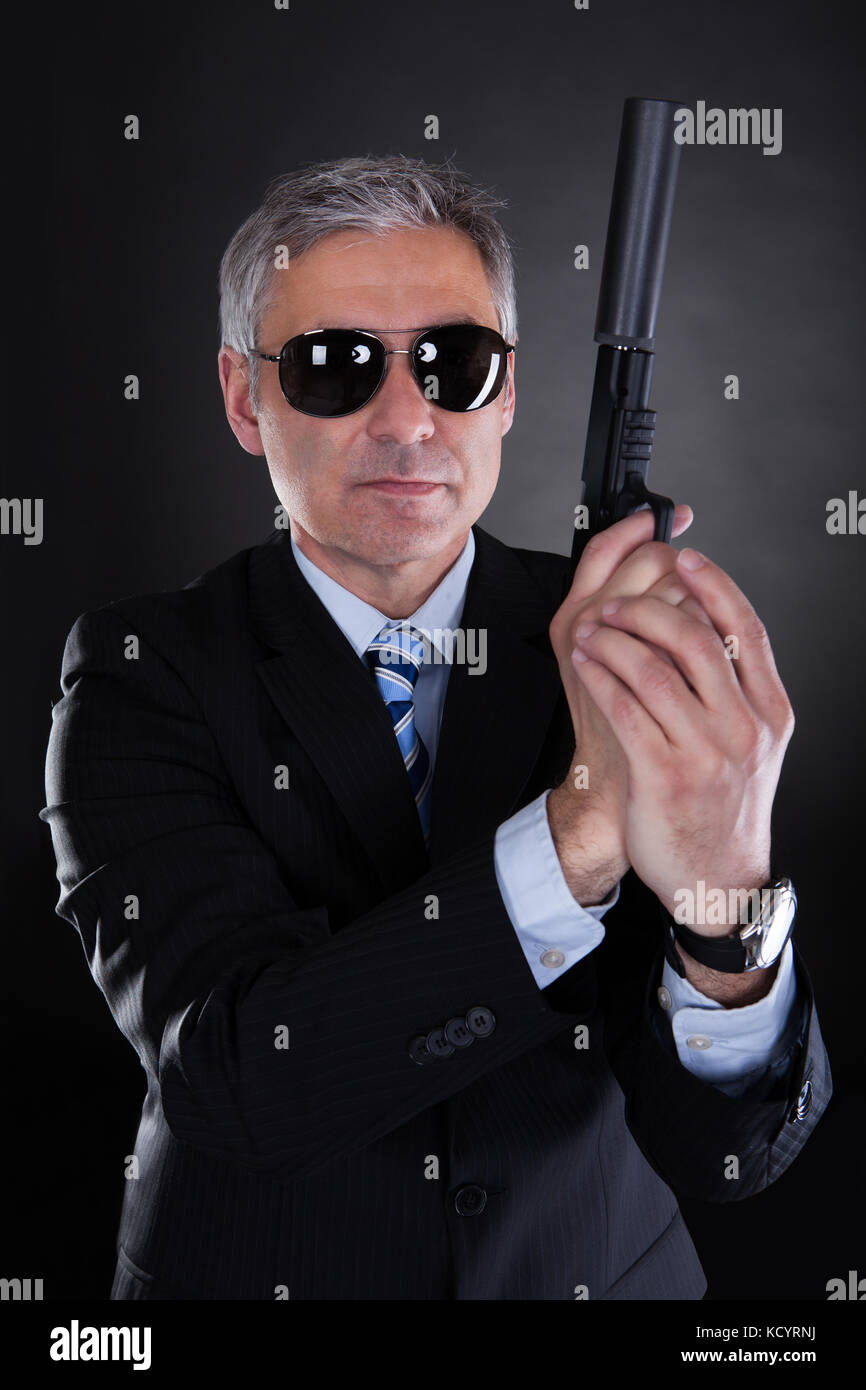 Close-up Of Male With Handgun Over Black Background Stock Photo - Alamy