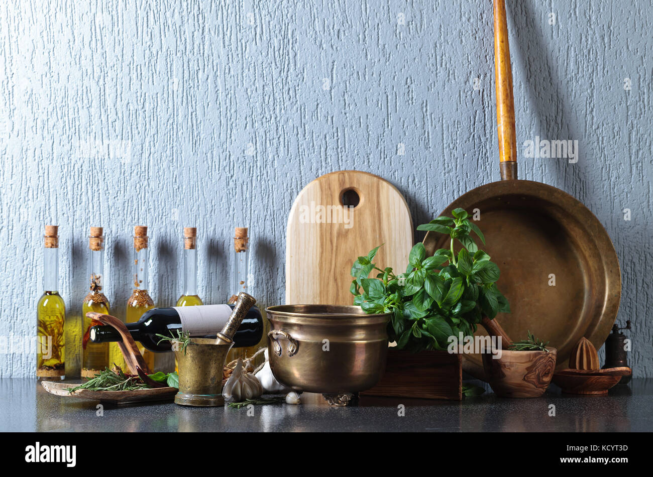 Vintage kitchen utensils with Basil and bottles of olive oil. Copy