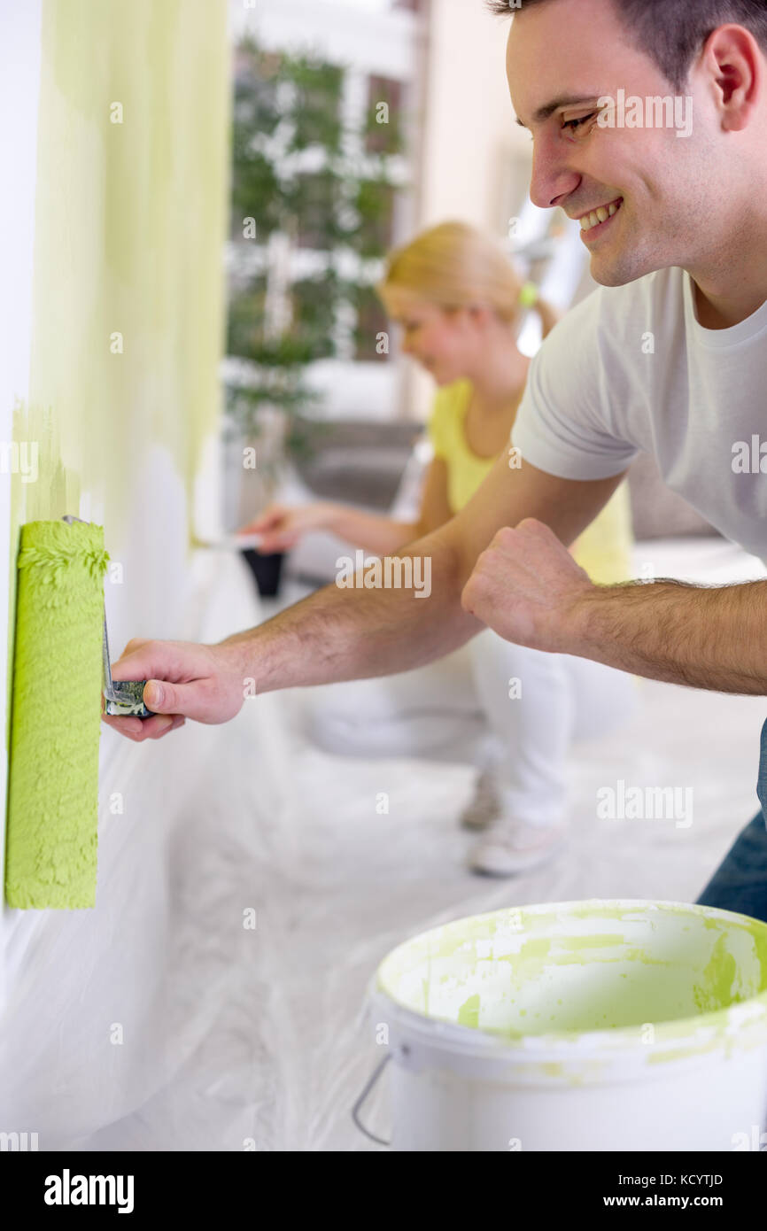 Woman painting wall in apartment hi-res stock photography and images ...